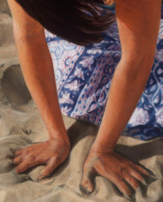 detail of hands in the sand
